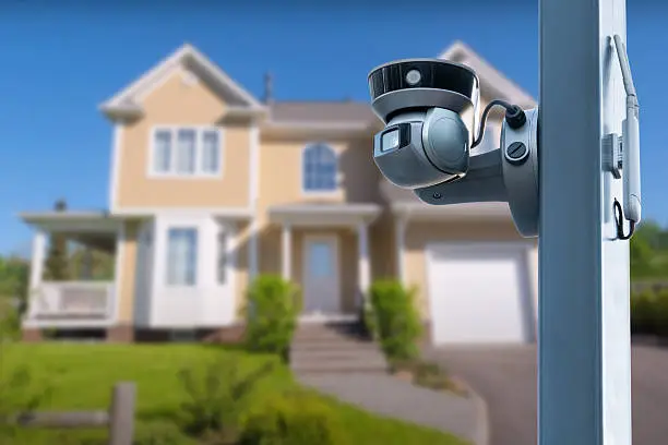Modern smart home security camera mounted outside house