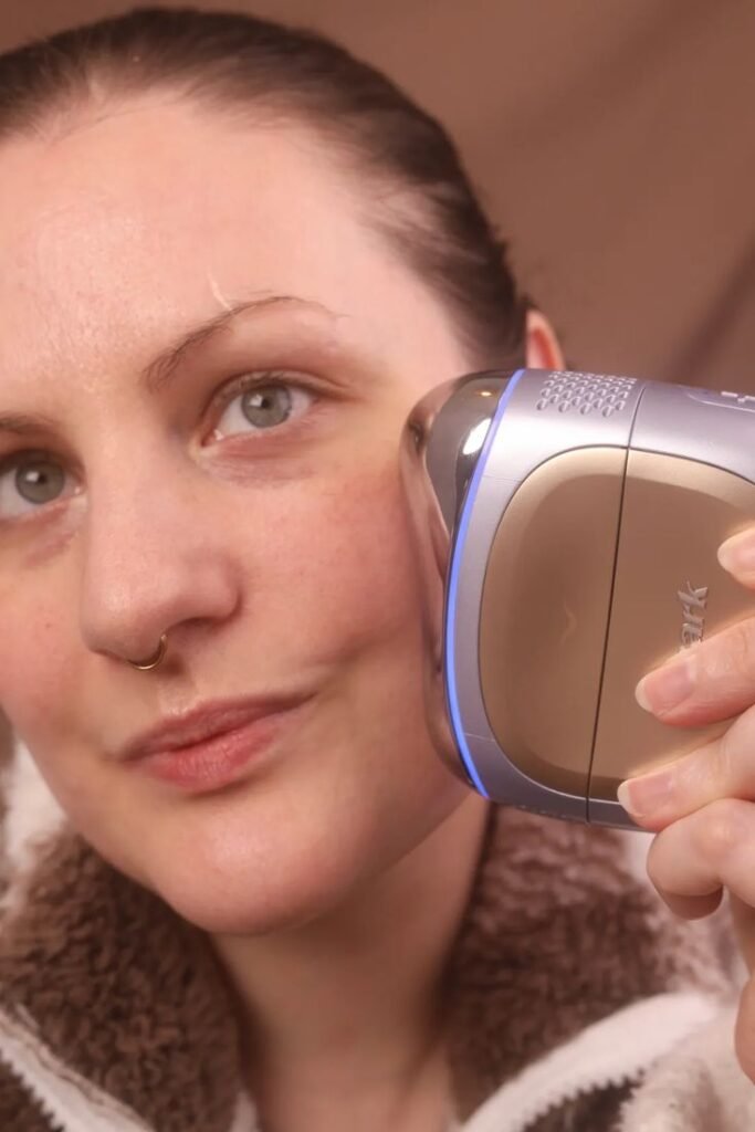 Person using Shark Depuffi facial device along the jawline